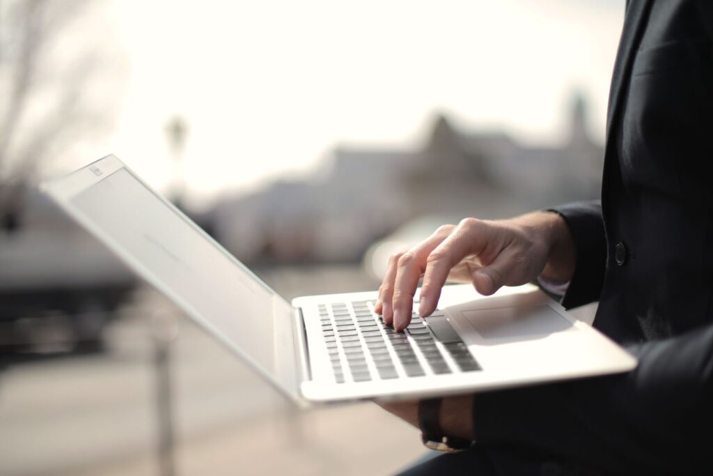 Writer testing an AI chatbot on a laptop outdoors