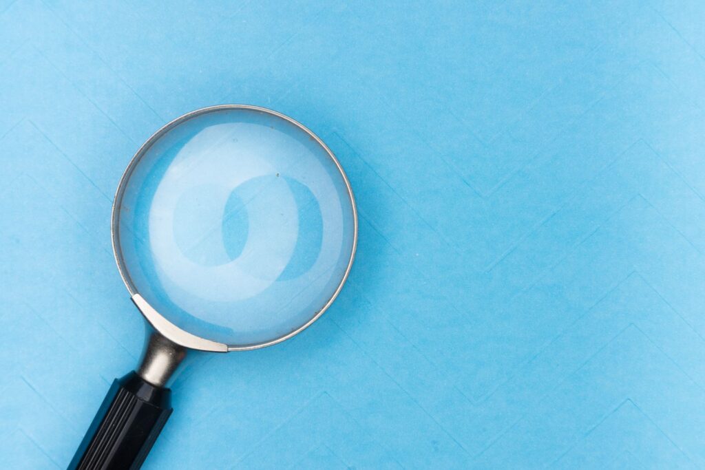 Magnifying glass on a blue background representing AI-powered search