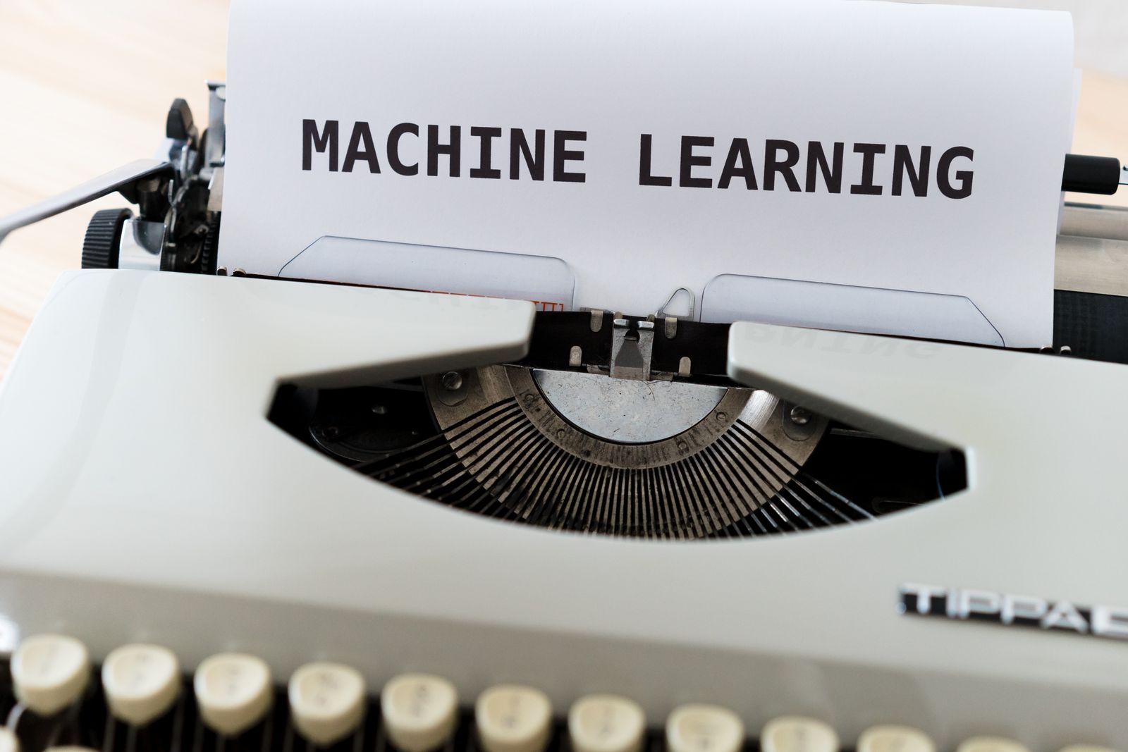 Typewriter printing a page that reads Machine Learning